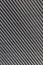 Hard diagonal shadows on grey textured wall from a window roller shutter or blinds. Attractive abstract composition