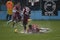 Hard football tackle on flooded field