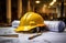 a hard hat sits on top of red blueprints on a table