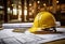 a hard hat sits on top of red blueprints on a table