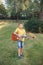 Hard of hearing preteen boy playing guitar outdoors. Child with hearing aids in ears playing music and singing song in park. Hobby