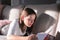 Hard light portrait of cute tween girl lying on sofa reading bookwith shadow on couch.