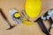 Hard safety helmet hat with air nailer tool construction gloves tape measure industrial safety glasses, knife, construction hammer