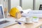 Hard safety helmet hat, construction equipment, blueprint on table in office worker conference site, architect working desk.