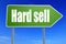 Hard sell word with green road sign