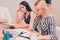 Hard work. beautiful worried and concerned businesswomen sitting at conference table, they reading