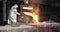 Hard work in the foundry. Pouring molten steel. Liquid steel pouring.