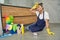 Hard work. Full length shot of tired, exhausted young woman taking a rest while cleaning floor with detergents at home