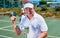 Hard work always pays off. Cropped portrait of a handsome mature man holding up a trophy after winning a tennis match