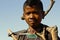 Hard working poor boy carrying a tree trunk - MADAGASCAR