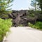 Hardened lava flow on road on slope of Etna