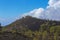 Hardened lava of the volcano on the background of blue sky.