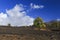 Hardened lava of the volcano on the background of blue sky.