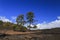 Hardened lava of the volcano on the background of blue sky.