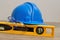 A hardhat, level and safety spectacles