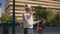 Hardhat man using walkie-talkie giving instructions to workers in modern city