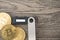 Hardware cryptocurrency wallet with golden Bitcoin BTC. Safe storage for crypto