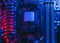 Hardware technology concept in neon light. Motherboard in blue-red light. Computer accessories. Dark photo