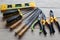 Hardware tools, equipment used for repair and maintenance work in general technicians isolated on wooden background closeup.