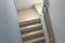 Hardwood stair steps and white wall