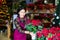 Hardworking flower shop employee tending flowers Poinsettias pulcherrima