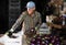 Hardworking man sorts ripe recently harvested eggplants in a warehouse