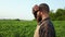 Hardworking, tired farmer standing on field, looking.