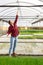 Hardworking young woman farmer opens a tap for watering