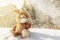 Hare rabbit fairy toy sitting on a snowdrift and waiting for Easter. it`s snowing and snowflakes are falling. Fabulous picture,