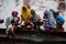 Haridwar, India - August 20, 2009: group of worshipers preparing flowers to leave in the waters of the Ganges at Haridwar,