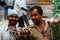 Haridwar, India - August 20, 2009: two Indian coconut sellers smile at the bus terminus for Rishikesh, Uttarakhand, India