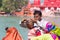 Haridwar, India - March 20, 2017: Man shaving off hairs for young Hindu devotee initiation on the Ganges River at Haridwar, India.