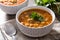 Harira soup in bowl on wooden table. Typical Moroccan food