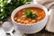 Harira soup in bowl on wooden table. Typical Moroccan food. RamadÃ¡n concept.