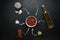 Harissa ingredients for cooking hot chilli red pepper, coarse sea salt, garlic, cumin zira, olive oil, ground coriander on a dark