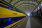 Harlem, Amsterdam, Netherlands - July 14, 2015: Inside railroad station, large roof covering platform, blue and yellow