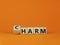 From harm to charm. Turned the cube and changed word `harm` to `charm`. Beautiful orange background. Business and harm or char