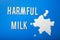 Harmful milk word text letters lactose intolerance allergy. milk splatter. avoid dangerous dairy