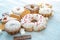 Harmful sweet foods on blue wooden background. Donuts and muffins on the table pile. Unhealthy diet and overweight