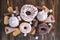 Harmful sweet foods on a dark wooden background. Donuts and muffins on the table pile. Unhealthy diet and overweight