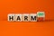 From harmful to harmony symbol. Turned a wooden cube and changed word harmful to harmony. Beautiful orange table, orange