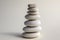 Harmony and balance, cairns, simple poise stones on white background, rock zen sculpture, white pebbles, single tower, simplicit