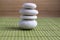 Harmony and balance, simple pebbles tower on green wooden background
