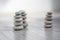 Harmony and balance, three cairns, simple poise pebbles on wooden light white gray background, simplicity rock zen sculpture