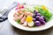 harmony of colors in a nicoise salad with purple potatoes included