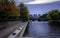 Harmony of Nature and Civilization. Tranquil Autumn Landscape with Footpath and Pond at Lechmere Canal Park in Boston.