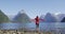 Harmony with nature - happy free woman with wanderlust enjoying Milford Sound