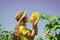 In harmony with nature. kid wear straw summer hat. child in field of yellow flowers. teen girl in sunflower field