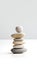 Harmony in Zen stone. Balanced stack of rocks symbolizes serenity and mental clarity. Neutral color, gray and white background,