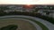 Harness Racers on Dirt Horse Race Track in Berlin, Germany at Sunset, Aerial follow tracking Shot from above